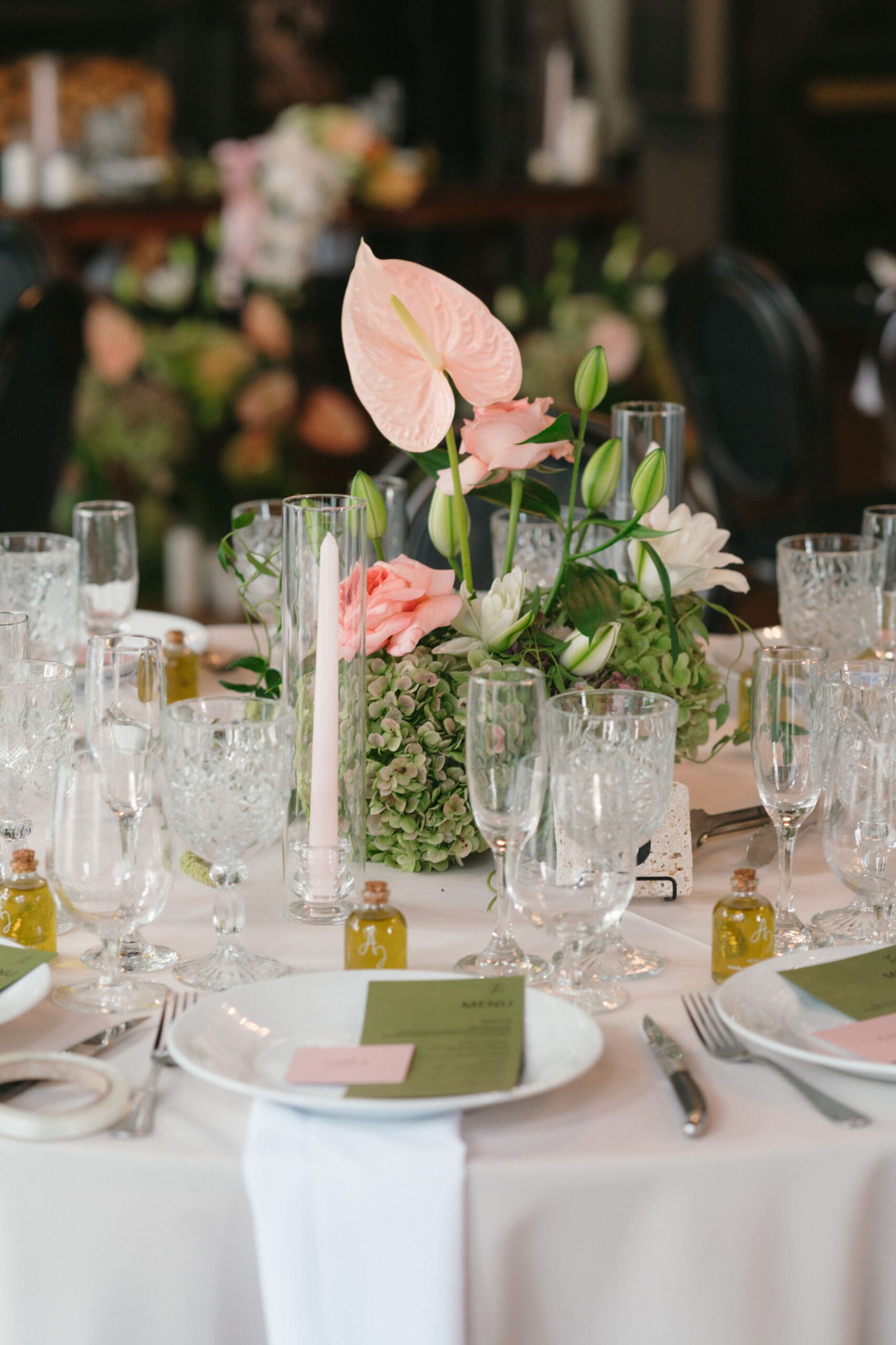 Table floral arrangements with Anthuriums and Dahlias.